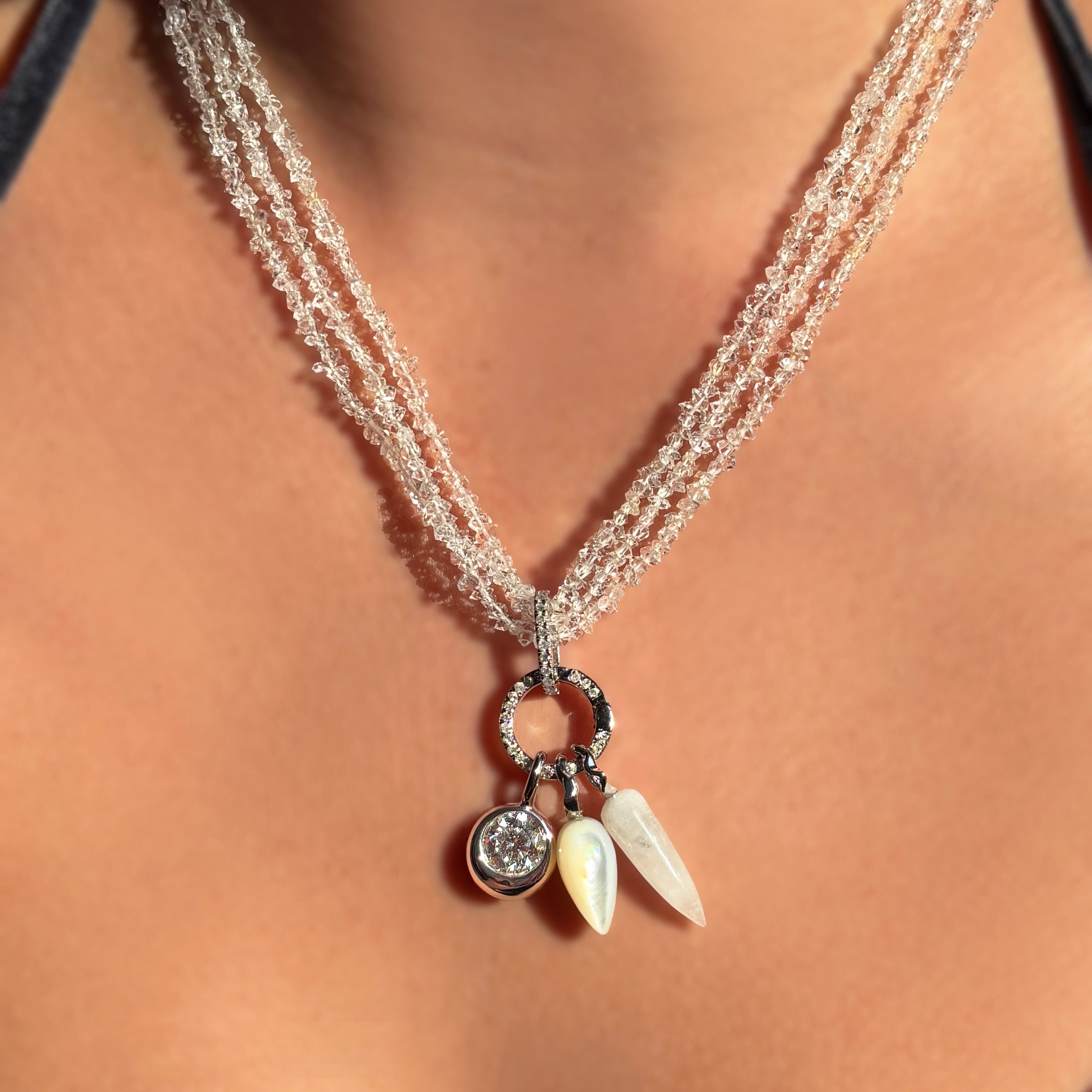 3 strands of herkimer diamond beads with white gold and diamond pavé charm locks hanging three charms.