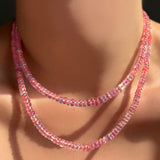 A 16" and 18" Hibiscus Sapphire Necklace layered together on a model's neck.