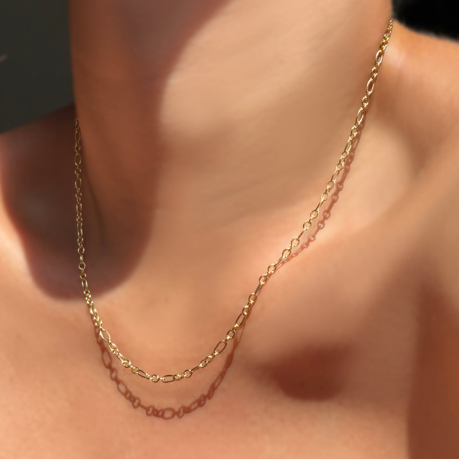 Irregular Cable Chain on a model's neck.
