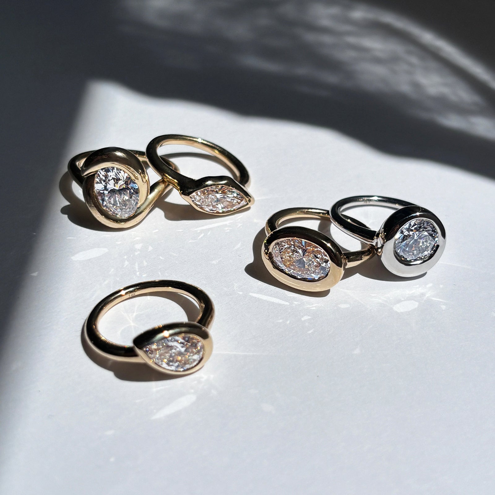 knot ring with diamond, molten solitaire rings with oval, pear, round, marquise diamonds.