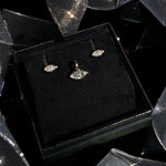 Marquise solitaire studs and charm boxed for a holiday gift with ribbons and holiday sparkle.