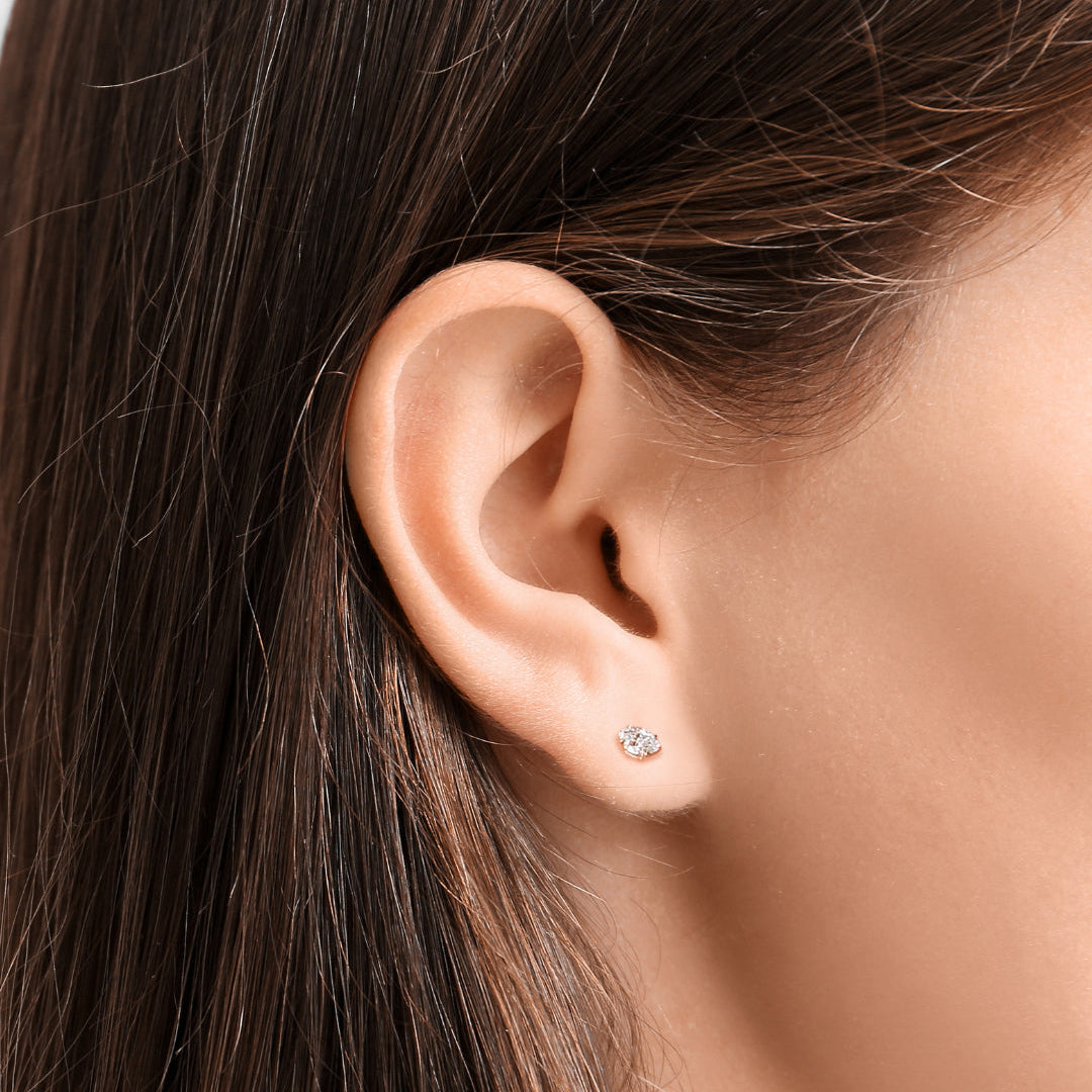 An AMANDA PEARL recycled 14k gold and ethical marquise cut diamond elements stud.