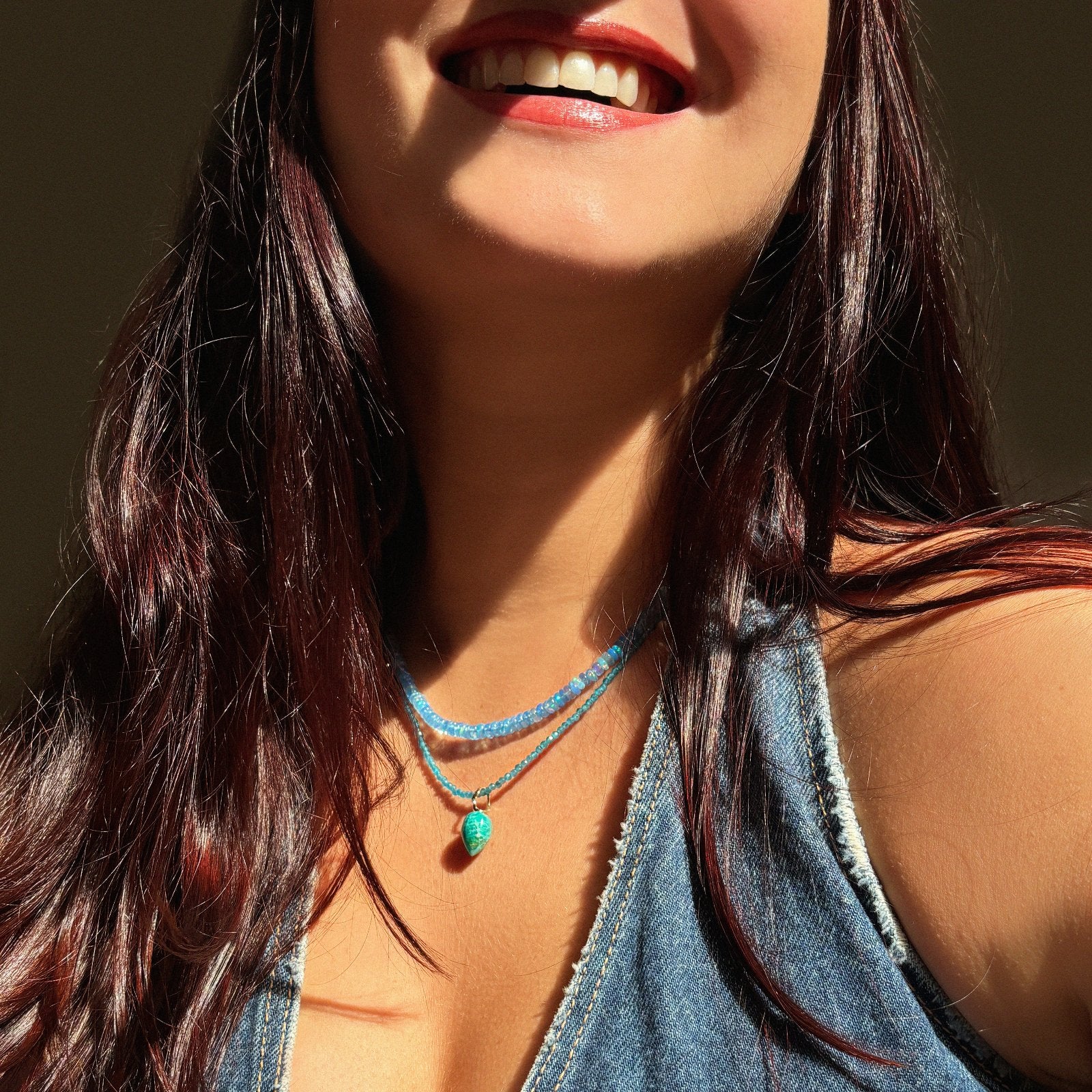 Chrysocolla acorn drop charm with flicks of teal, gold and blue with 14k gold ripple bale on a slim gemstone necklace and demin blue opal necklace