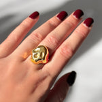 Molten skull ring on a model's hand