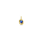 molten solitaire knot charm with star sapphire in yellow gold on a white background next to a ruler.