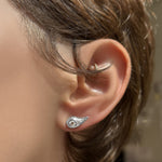 Molten stud in 14k white gold with diamond pavé on the ear of a short haired brunette.