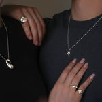 Models wearing black and grey tees and AMANDA PEARL sterling silver jewelry.