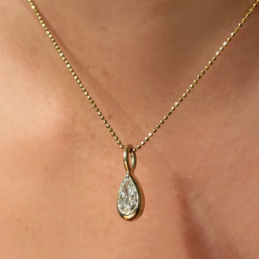 14K Recycled Gold Molten Solitaire Charm in Pear on the diamond cut bead chain 