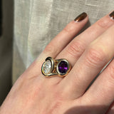 Molten knot ring with deep, rich purple amethyst gemstone paired with a molten knot ring with diamond on a model's hand.