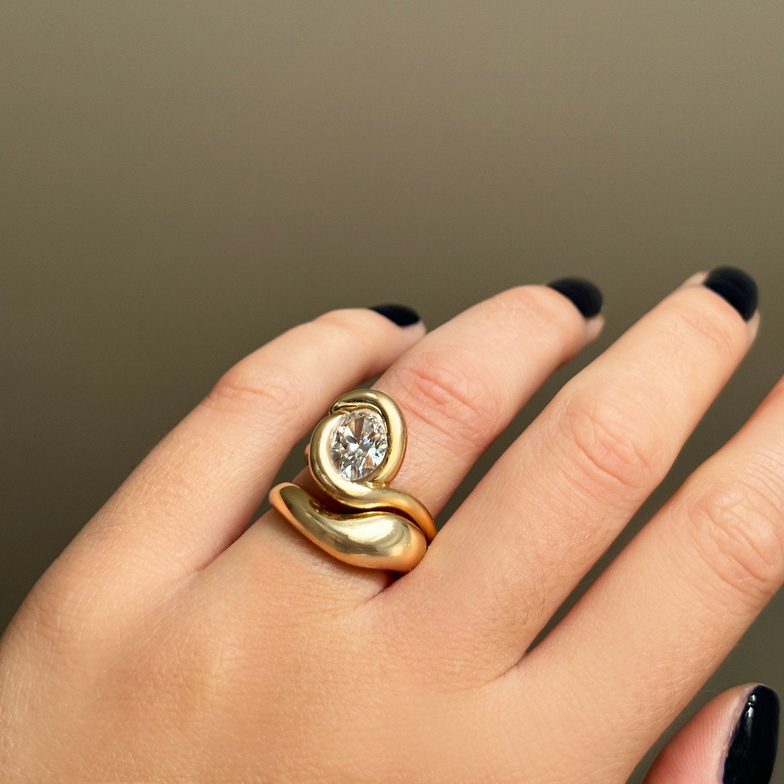 14K recycled gold Molten Ring styled on a hand stacked with the molten knot ring 