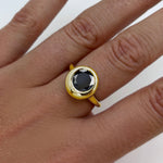 AMANDA PEARL recycled 14k gold Molten Solitaire Ring with black onyx gemstone on a model's hand.