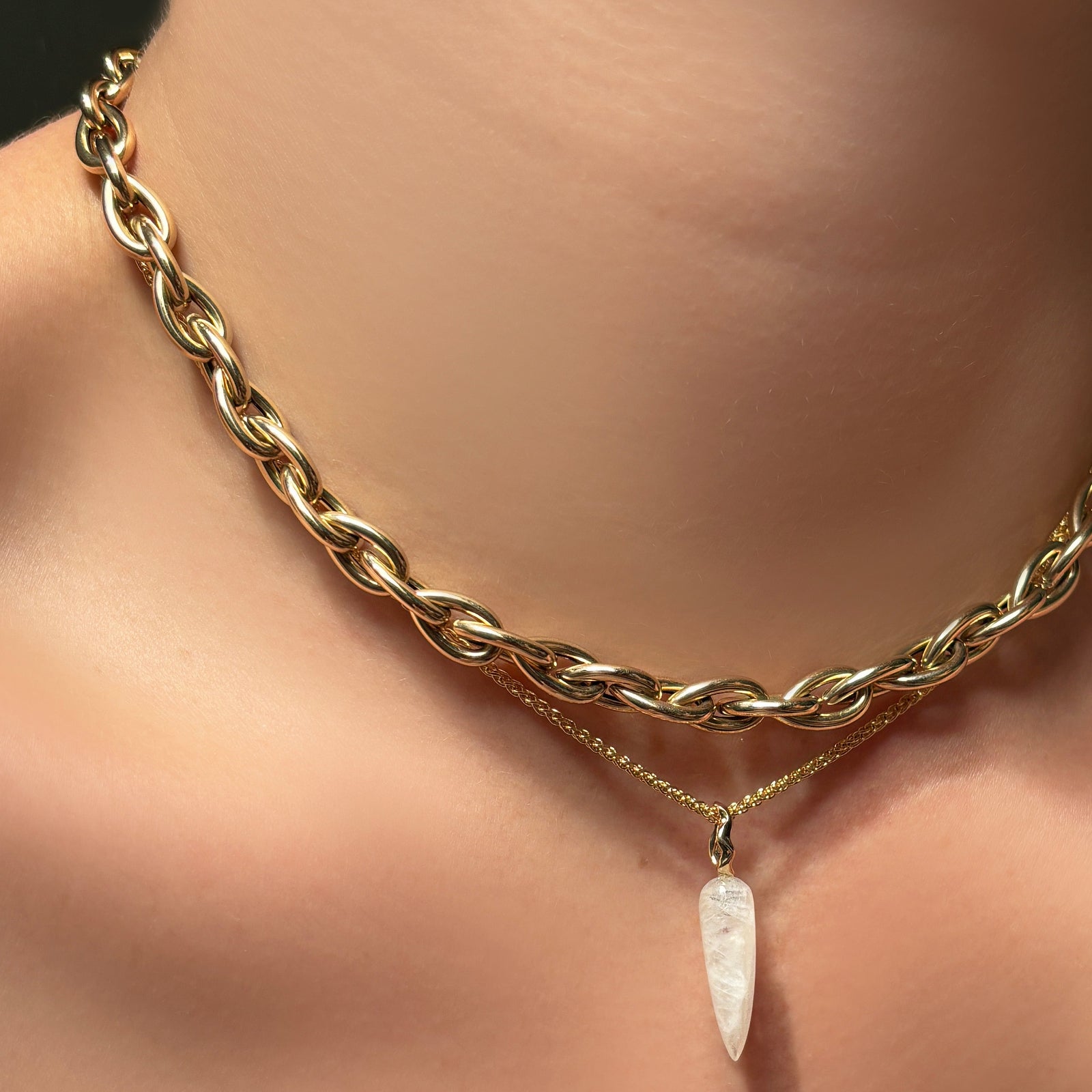 14k gold drop link chain necklace layered over a wheat chain with moonstone drop charm.