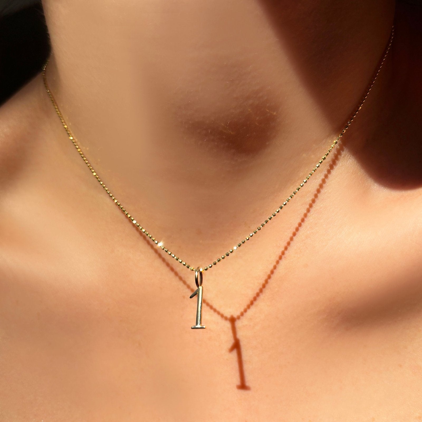 14K Recycled Yellow Gold Number 1 Charm styled on a chain