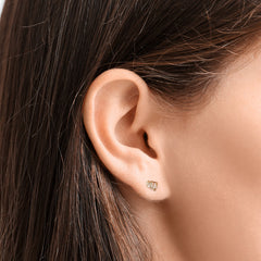 Close-up of an AMANDA PEARL Elements ethical diamond stud earring on a model's ear.