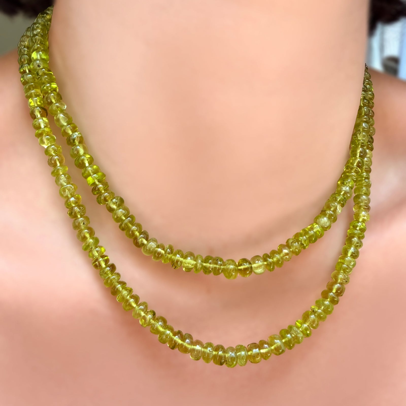 2 strands of AMANDA PEARL Peridot Rondelles on a model's neck.