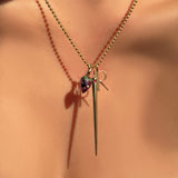 2mm bead chain with ruby zoisite drop charm, quill spike charm with ruby, and letter "R" charm in yellow gold on a model's neck.