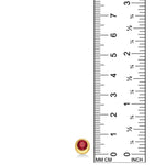 Molten solitaire stud with ruby against a white background next to a ruler.