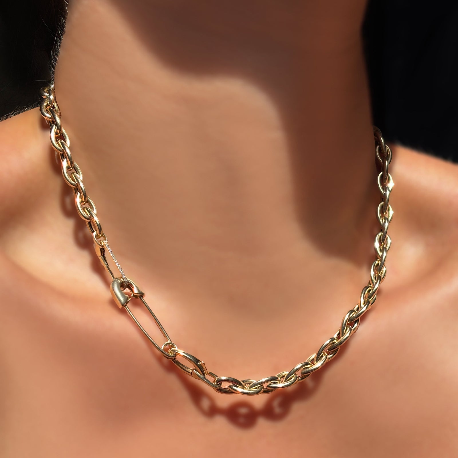 14k yellow gold drop link chain necklace with a safety pin charm lock and medium diamond pavé charm lock in the clasp.