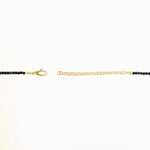 Shimmering beaded necklace made of 2.5mm faceted opals in shades of black on a gold linking lobster clasp.