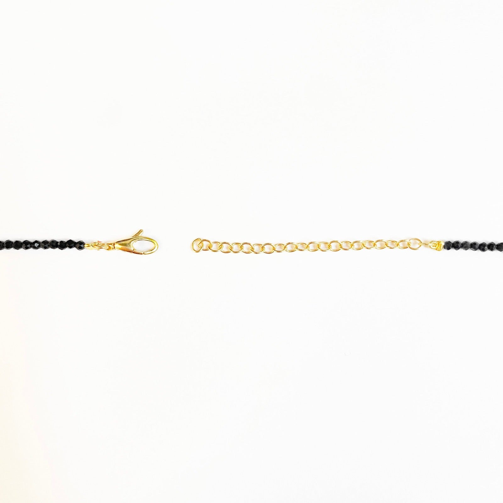 Shimmering beaded necklace made of 2.5mm faceted opals in shades of black on a gold linking lobster clasp.