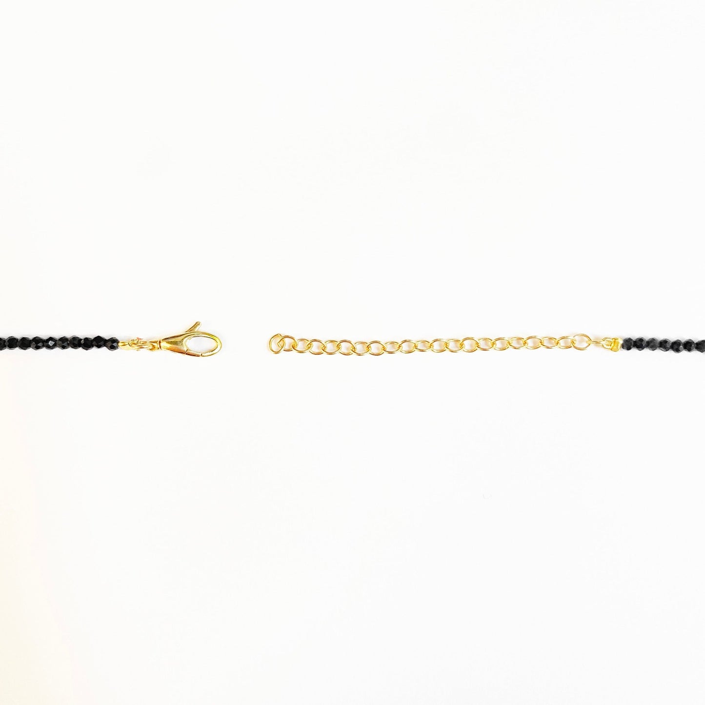 Shimmering beaded necklace made of 2.5mm faceted opals in shades of black on a gold linking lobster clasp.