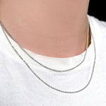 AMANDA PEARL sterling silver diamond cut bead chains on a model's neck over a white tee.