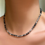 AMANDA PEARL faceted rutilated quartz necklace with sterling silver evolution clasp on a model's neck.