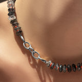 Triple link charm lock in white gold on a rutilated quartz collar with neon red thread.