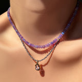 violet faceted opal necklace with iolite slim gemstone necklace with amethyst molten knot charm on the neck.