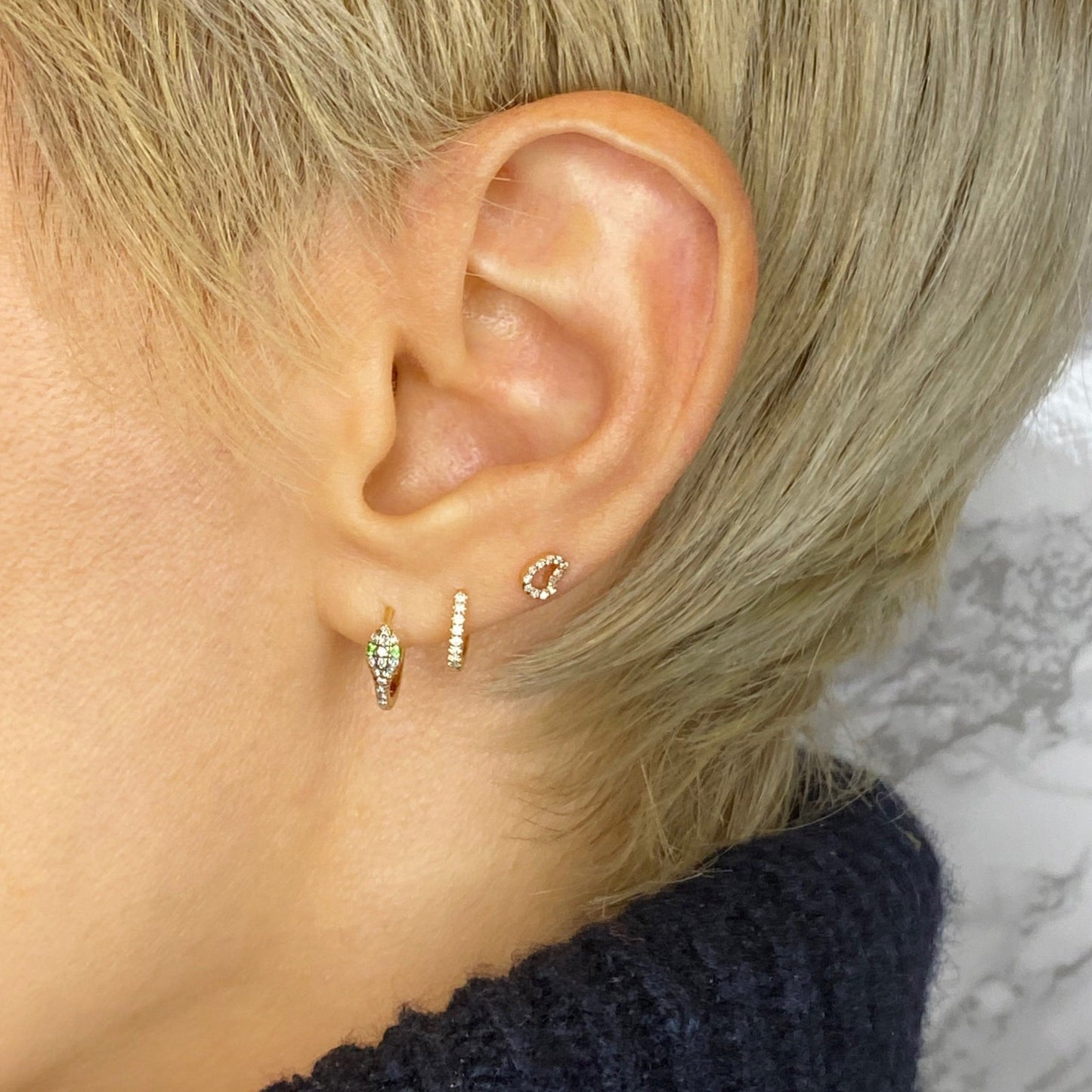 14k gold 10mm Diamond Pavé Hoop Earring styled on a ear