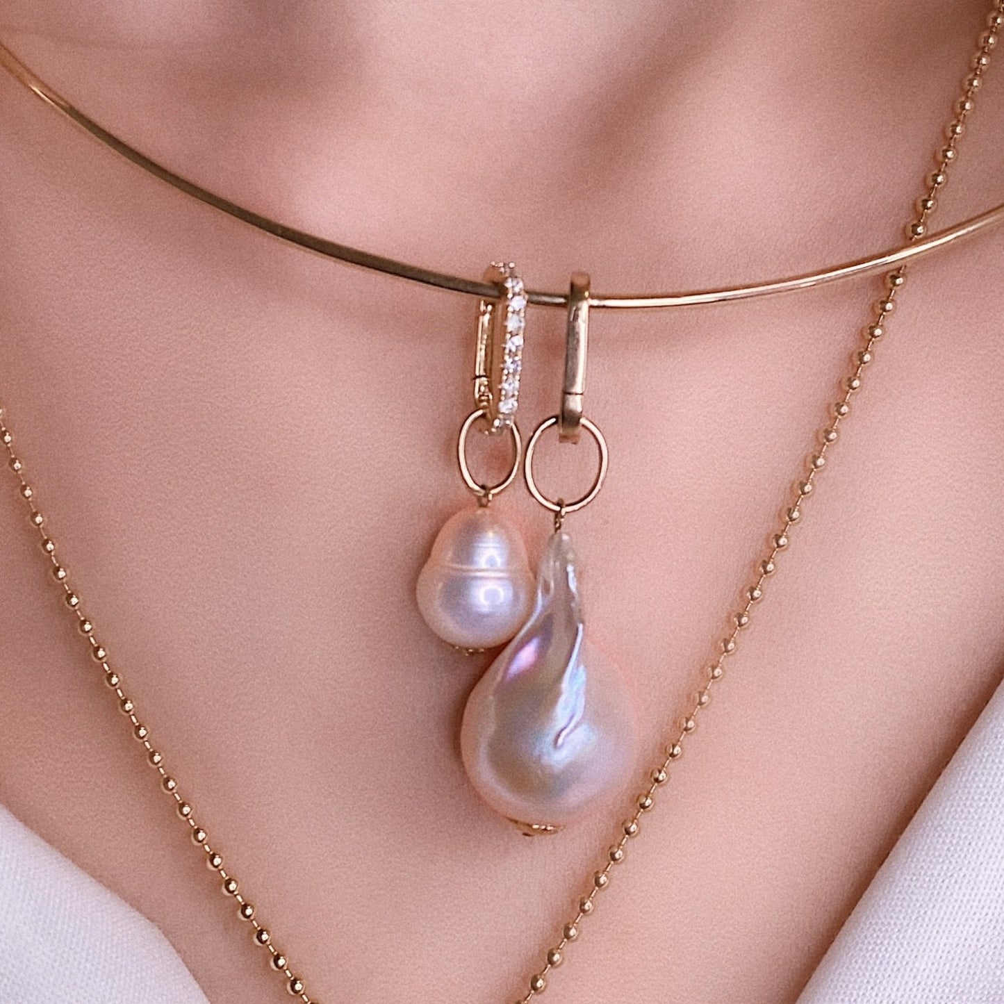 14k yellow gold small oval locking charm with diamonds. Styled on a neck locked onto a wire choker necklace and mini baroque pearl charm.
