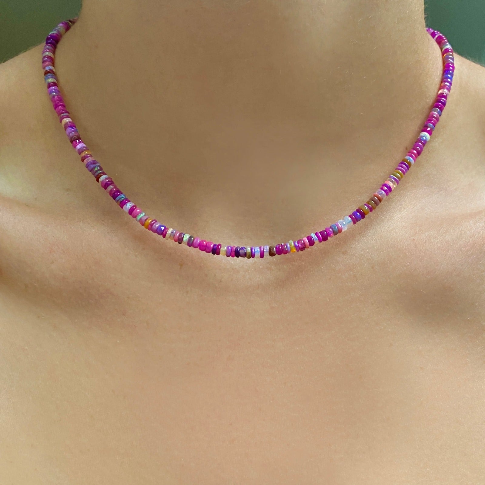 Shimmering Fuchsia Opal Necklace of smooth opals with various shades of pink, styled on a neck